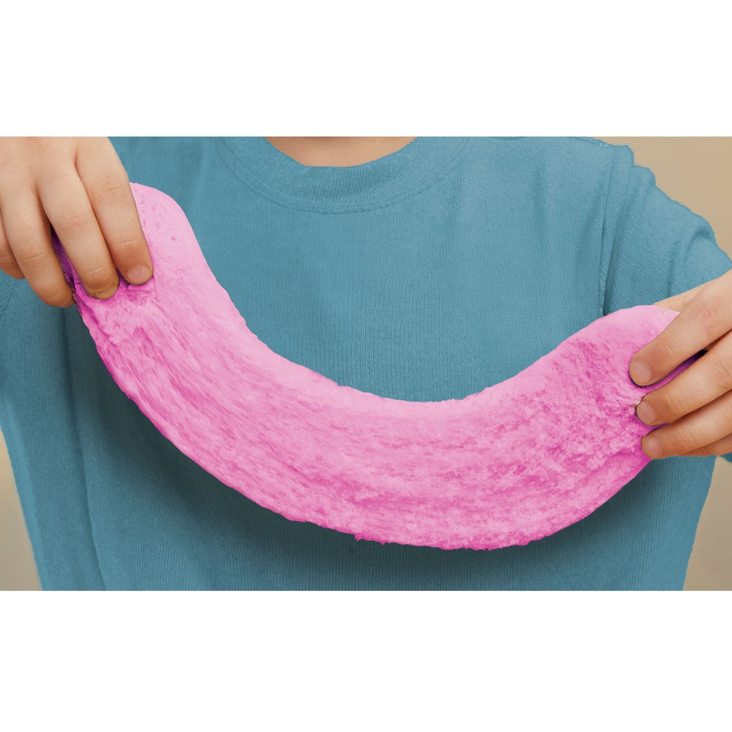 Boy holding a large piece of the strawberry dough