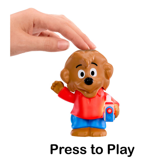 Toy figure of a bear with a hand pressing a button labeled 'Press to Play' on a white background