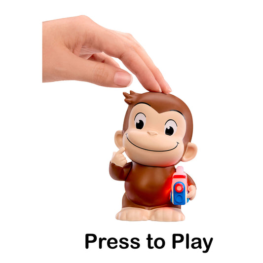 Curious George toy figure with a hand pressing the top button, holding a Story Dream Machine, with 'Press to Play' text below on a white background.