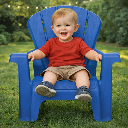 Child sitting in a blue chair outdoors on grass