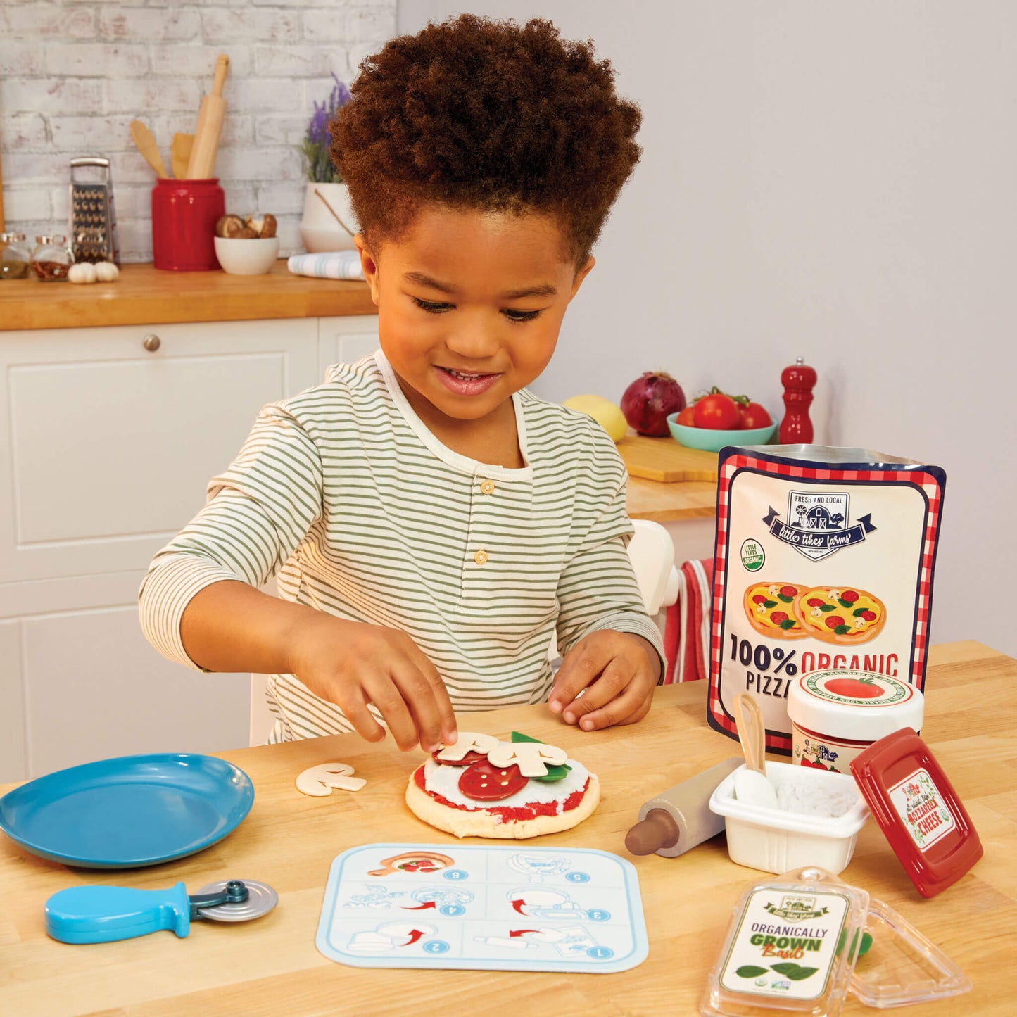 Boy adding toppings