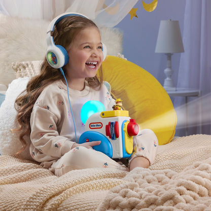 Child wearing headphones holding a Story Dream Machine in a cozy room