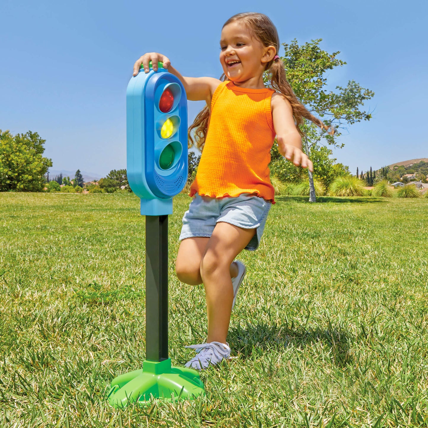Girl pressing green button on top of game