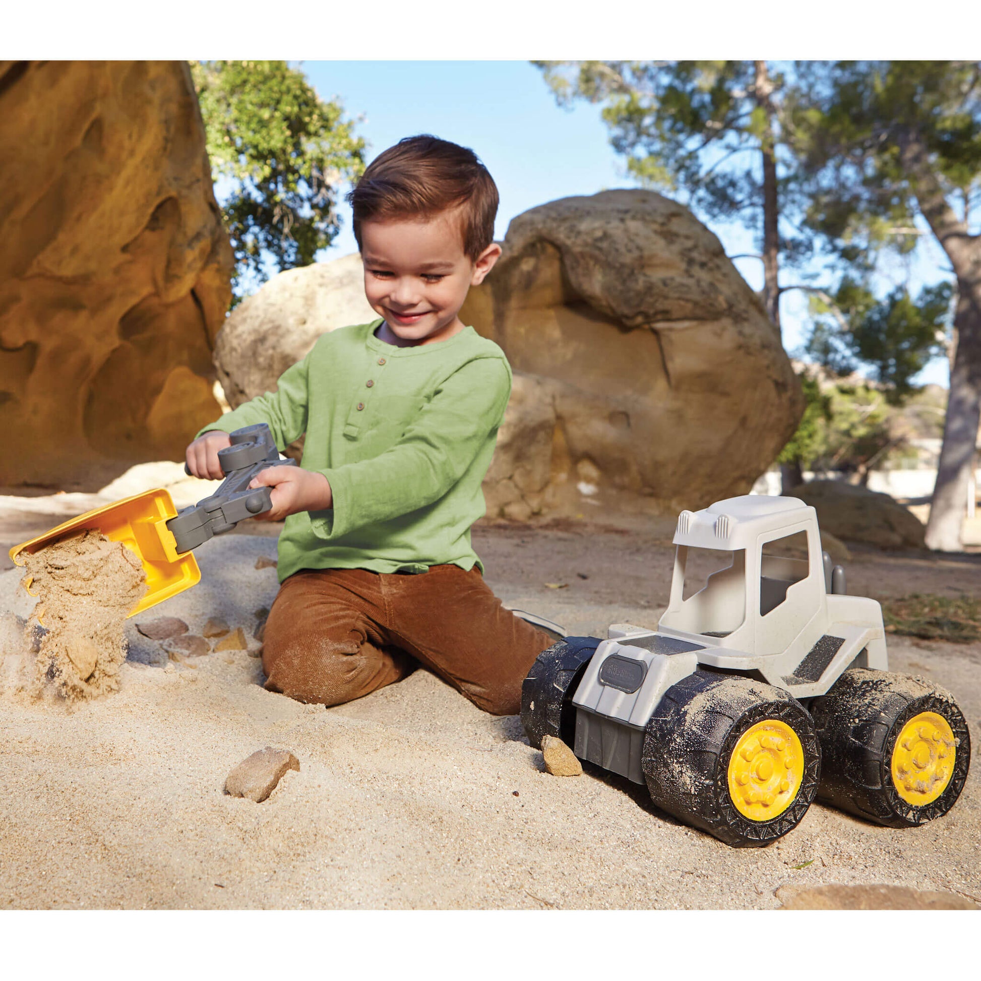Boy using scoop as a shovel