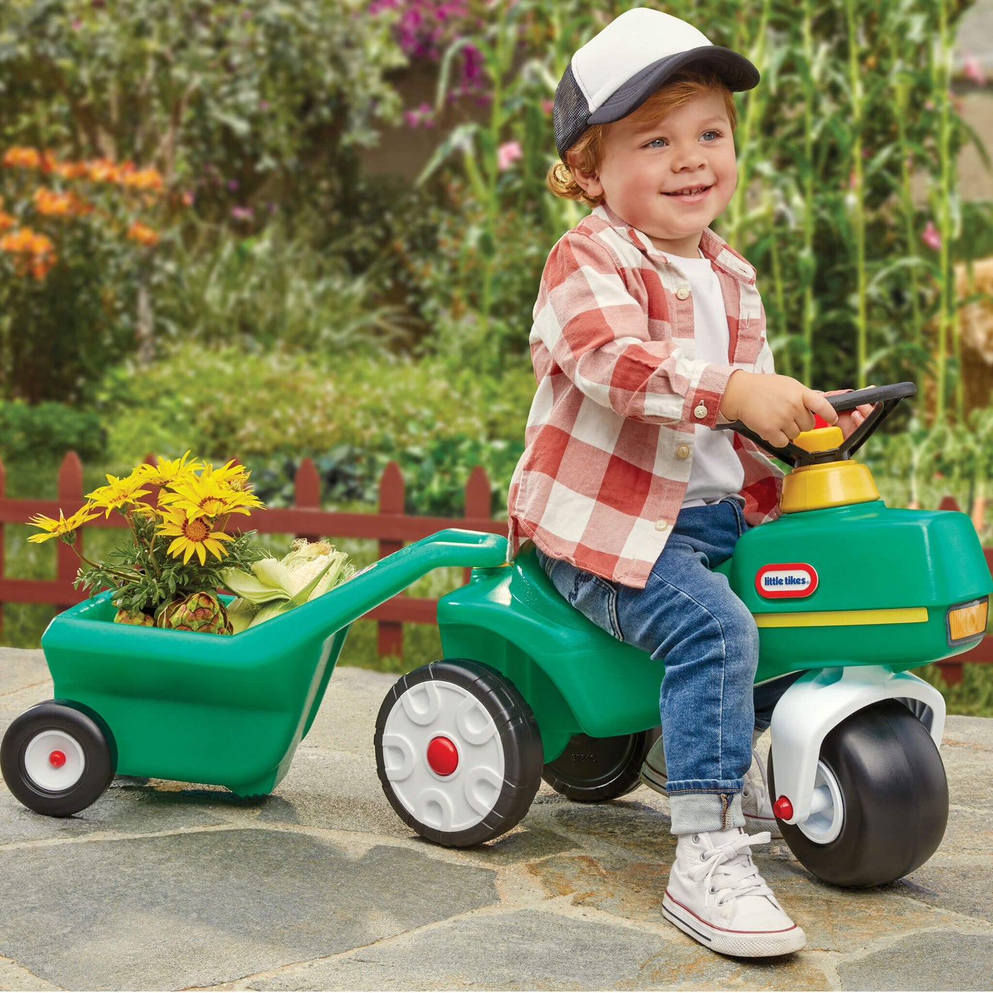 Boy riding on the tractor pulling the cart