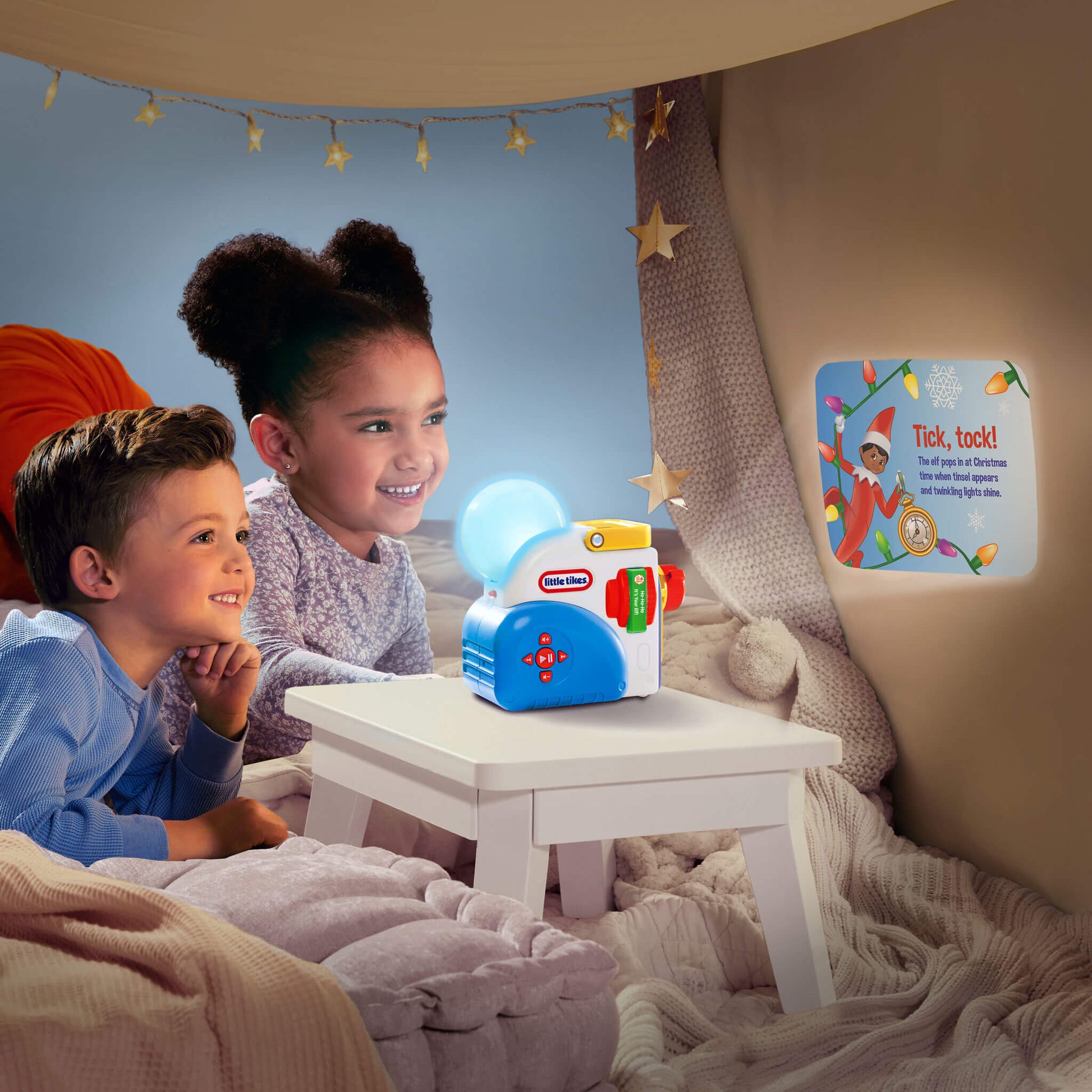 Two children sitting in a cozy room watching the story on the wall.