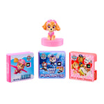 Toy Skye figure with three colorful packaging boxes on a white background