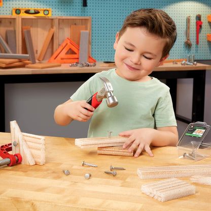 Child playing with a toy hammer and nails