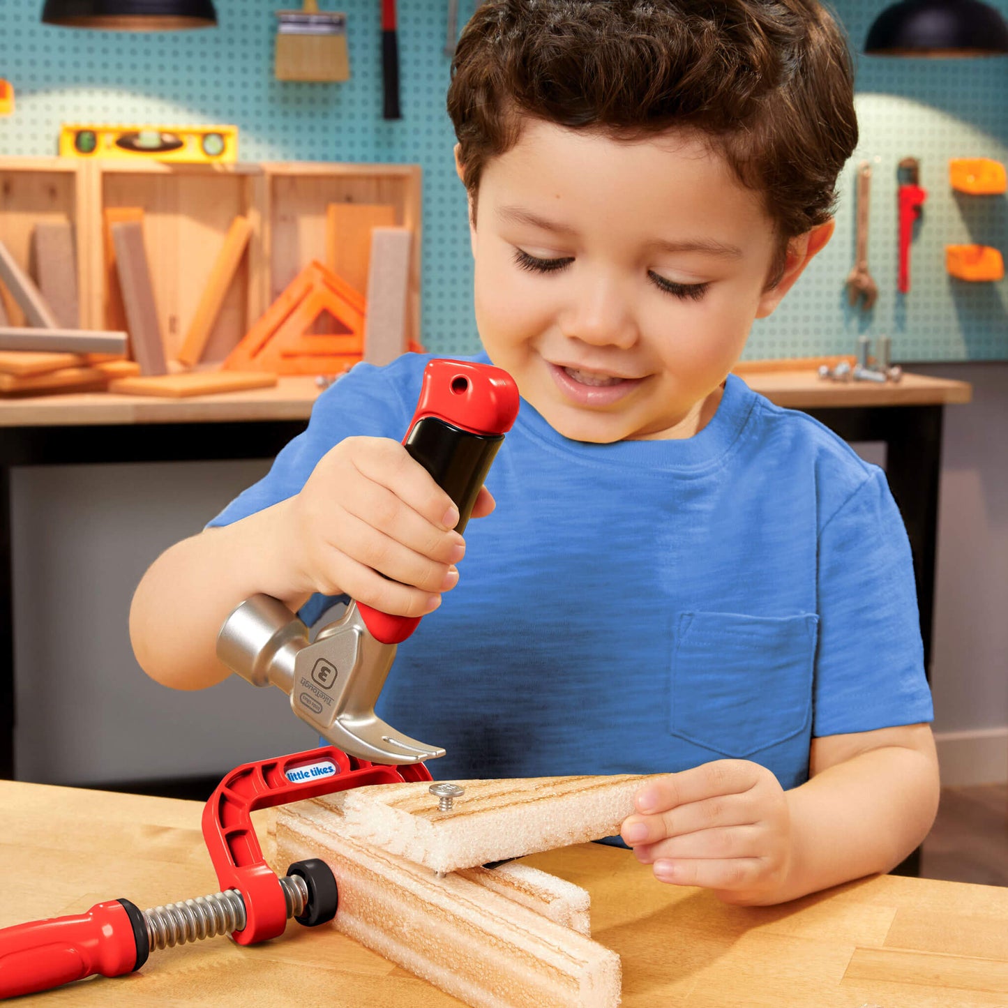 Child playing with toy hammer