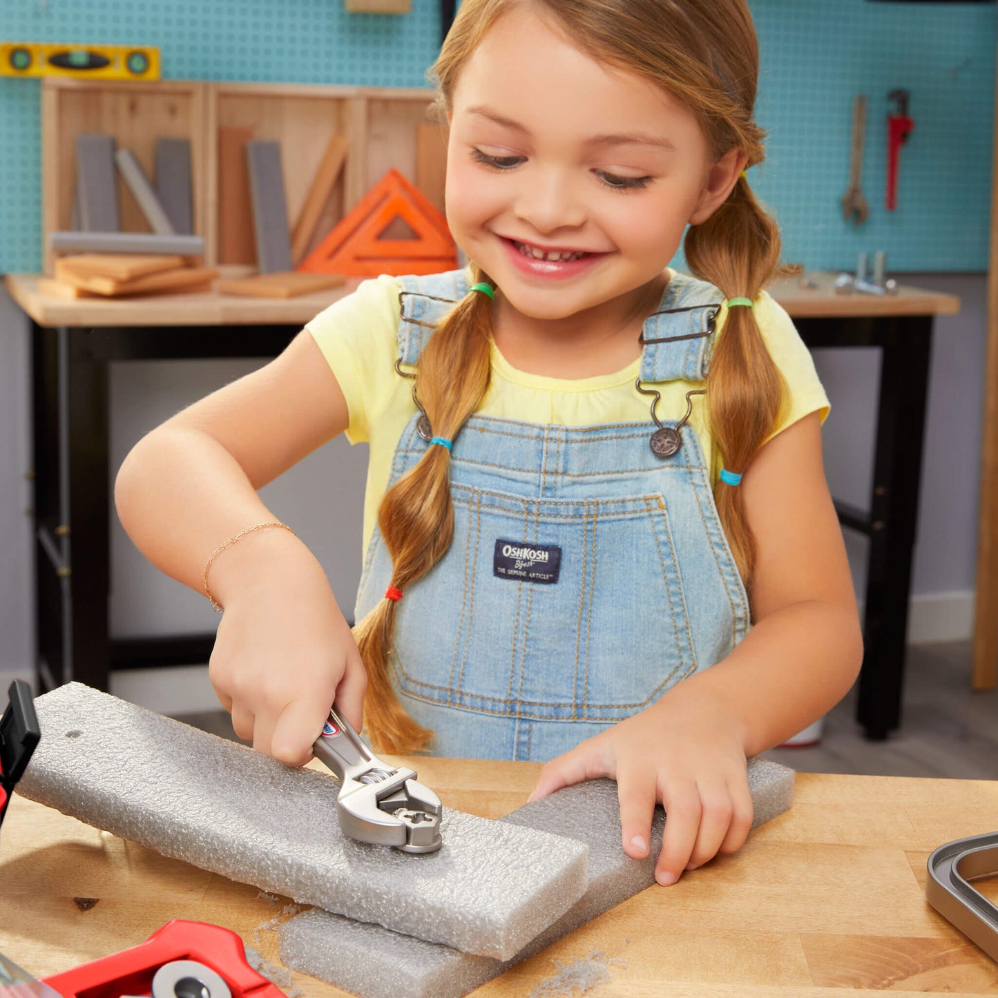 Girl in a workshop setting using tools