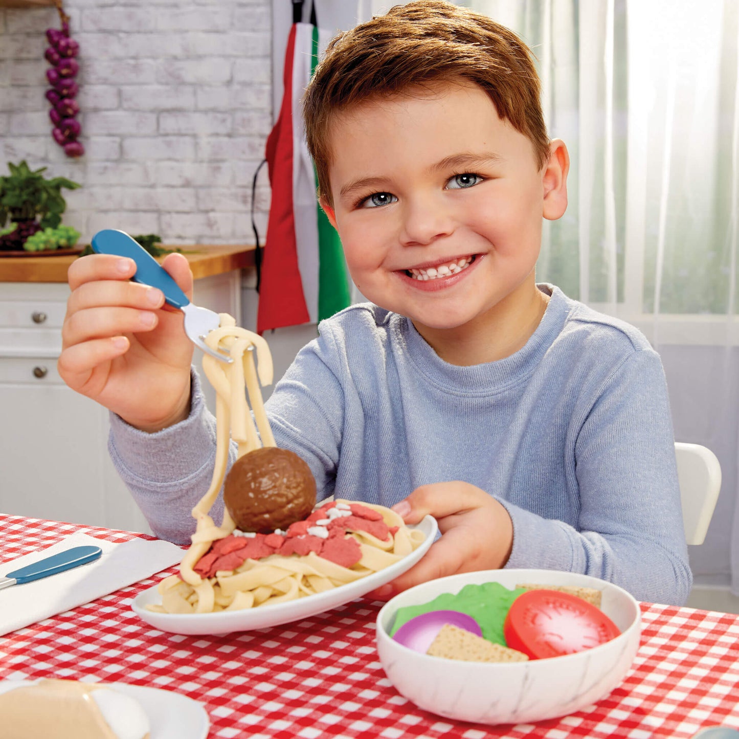 Child playing with spaghetti