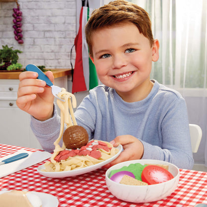 Child playing with spaghetti