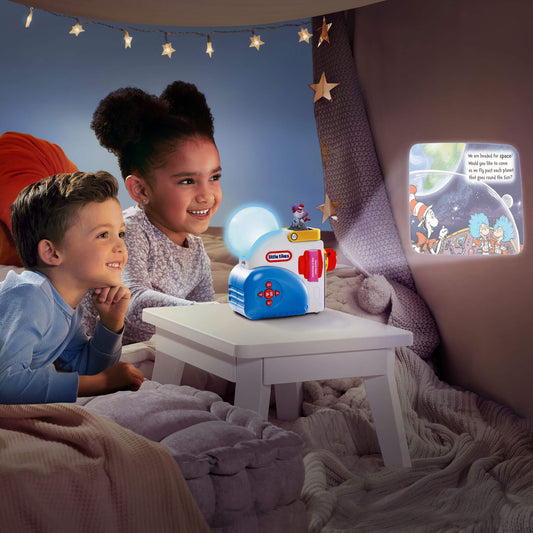 Two children in a cozy room with a Little Tikes toy and star decorations.