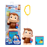 Curious George toy set including the character figure holding a Story Dream Machine, a yellow cloud-shaped keychain, and a small Story Dream Pals book on a white background.