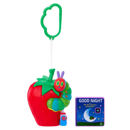 Toy strawberry with a caterpillar character and a 'Good Night' book on a white background