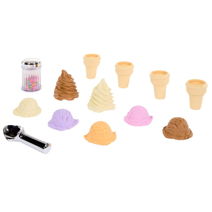 Set of ice cream cones and scoops of ice cream, sprinkles and a ice cream scooper on a white background