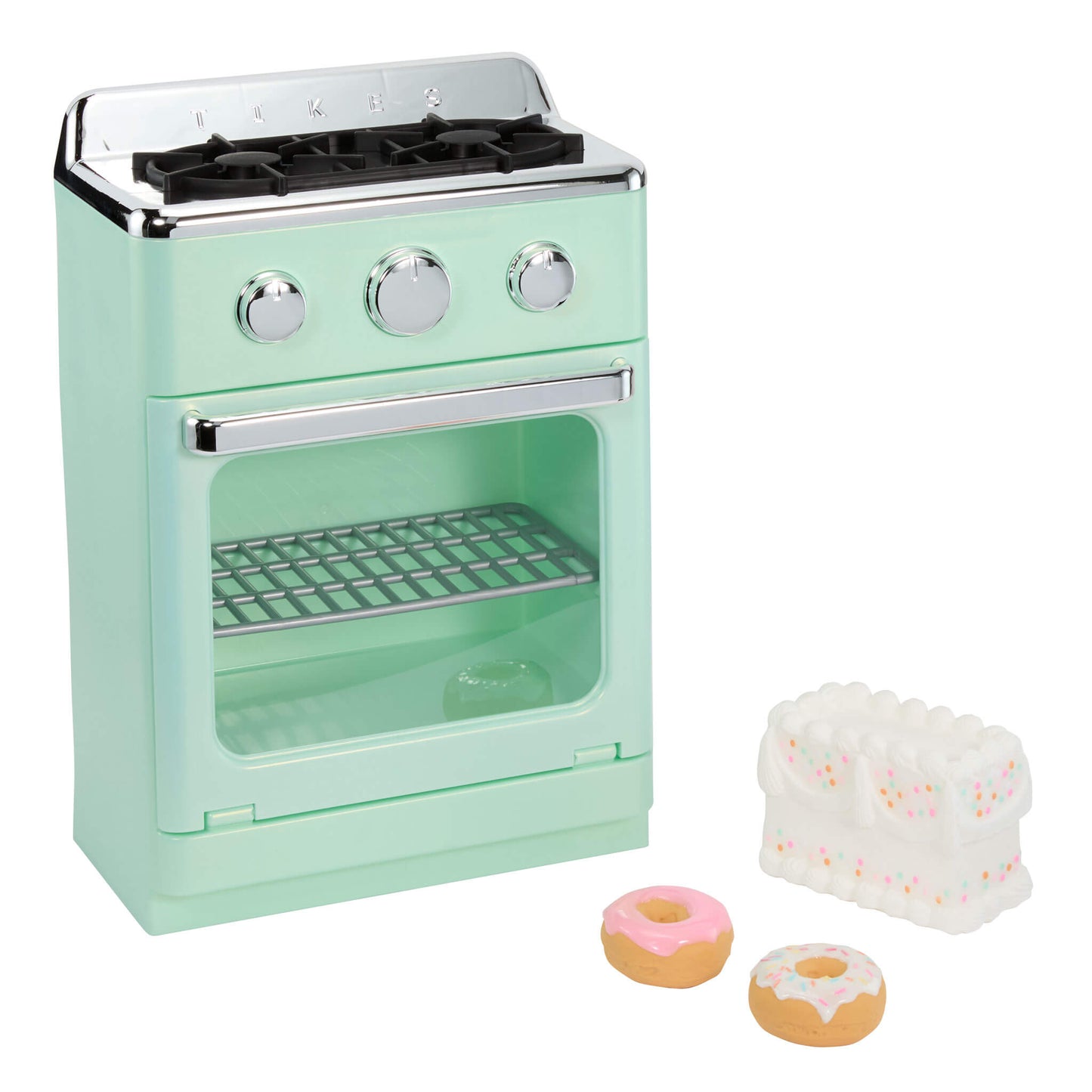 A mint green toy retro-style stove oven with silver knobs and a door, shown on a white background with two small donuts and a white frosting cake piece beside it.