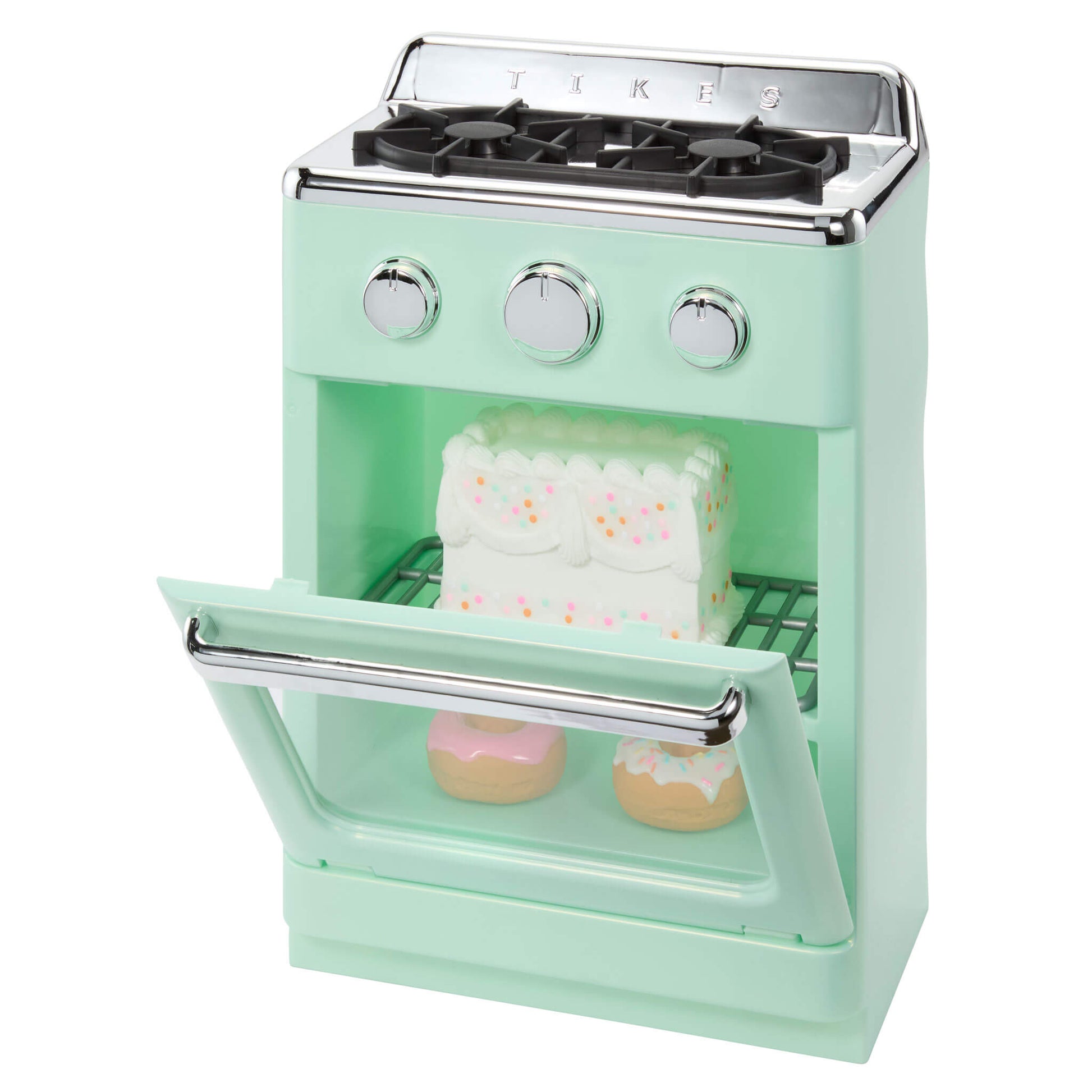A mint green toy retro-style stove oven shown on a white background with two small donuts and a white frosting cake piece placed inside.