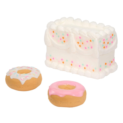 shown on a white background-two small donuts and a white frosting cake