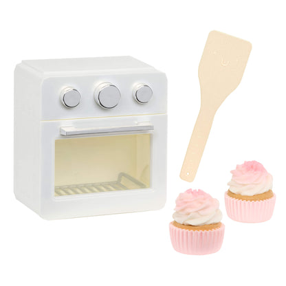 White oven, two cupcakes and a spatula on a white background