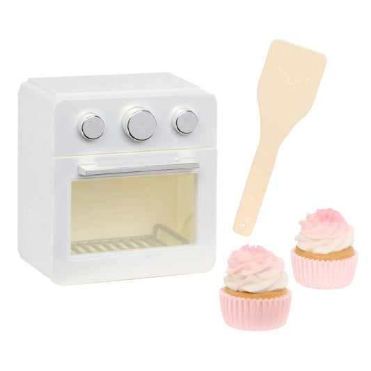 White oven, two cupcakes and a spatula on a white background