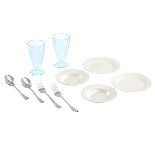Dinnerware set with white plates, silver cutlery, and blue glasses on a white background