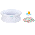 A white inflatable with a quilted diamond pattern, shown alongside a pile of pastel pink, mint green, and white ball toys and a small yellow pump accessory on a plain white background.