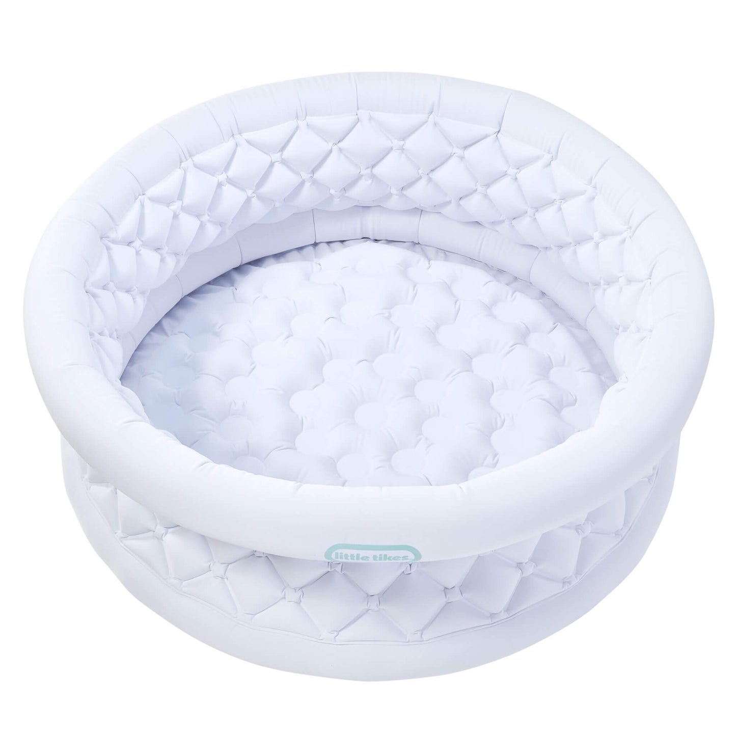 A white inflatable with a quilted diamond-patterned rim and a matching padded interior, shown on a plain white background. A small light blue-green brand label reading 'little tikes' is visible on the front edge.