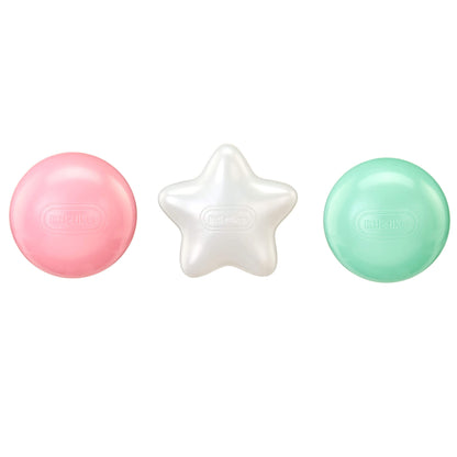 Three balls on a white background: a pink round ball, a white star-shaped ball and a mint green round ball.