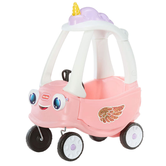 A pink toy ride-on car with a smiling face, large blue eyes, black wheels, a white roof frame, and a gold wing decal on the side.