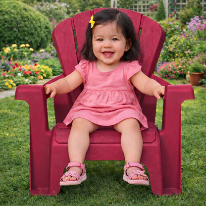 Child sitting on red chair with an outdoor background