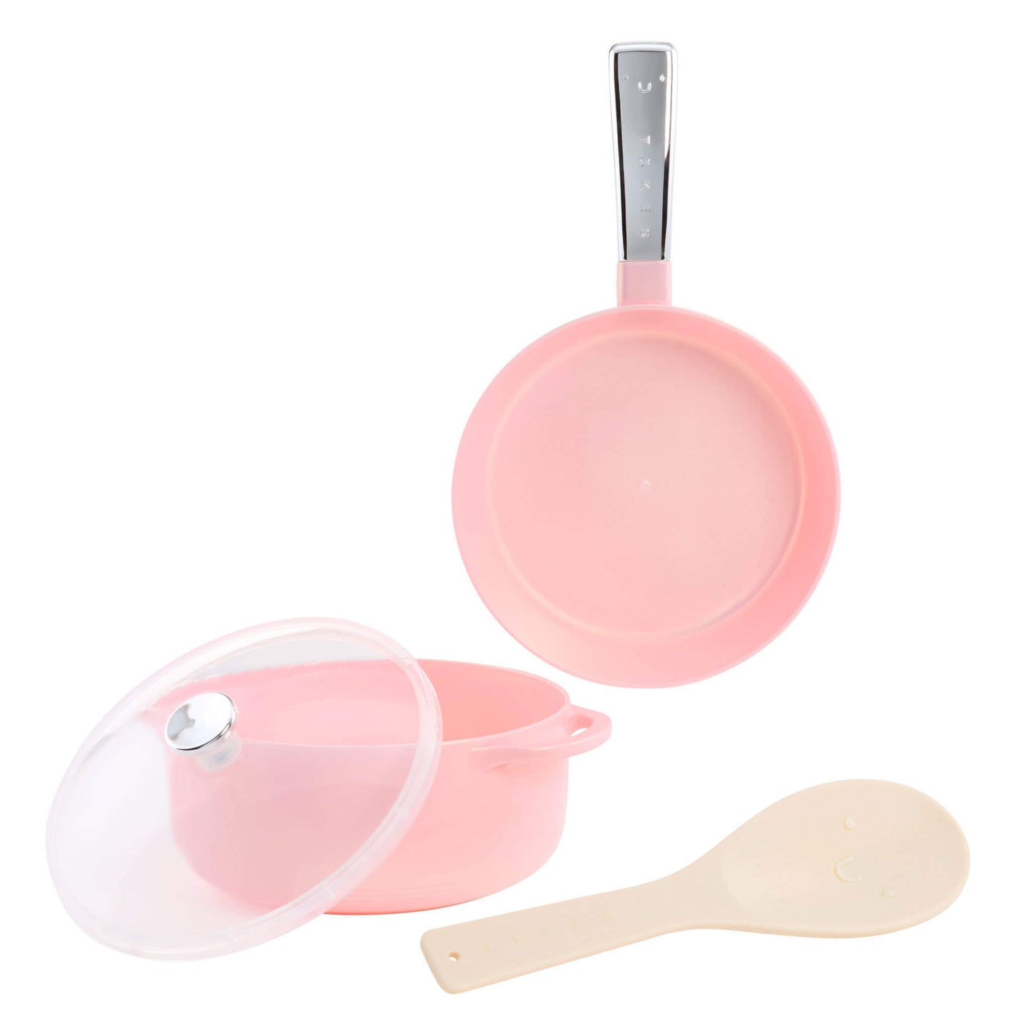 A pink cooking set on a white background, including a small frying pan with a silver handle, a pot with a clear lid, and a beige silicone spatula.