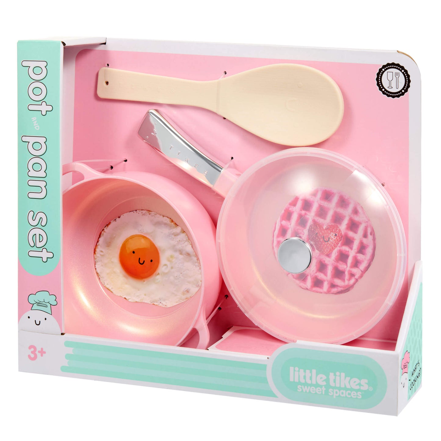 A children's toy cooking set in its retail box, featuring pink plastic pots and a lid, and a beige spoon. The packaging is white and mint green with the brand name 'little tikes sweet spaces' visible.