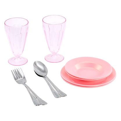 A children's dinnerware set featuring two pink goblets, a stack of four pink plates, and silver metal cutlery pieces, displayed on a clean white background.