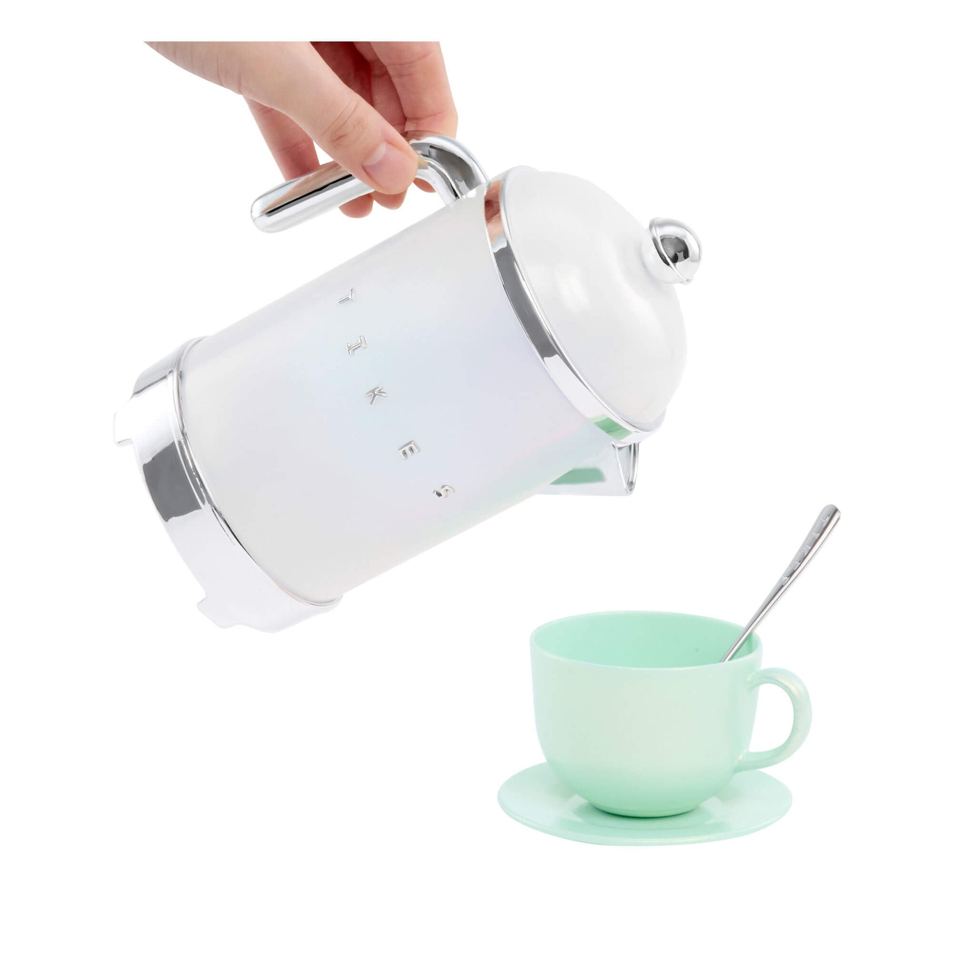 Hand "pouring" the tea pot into a green cup on a white background