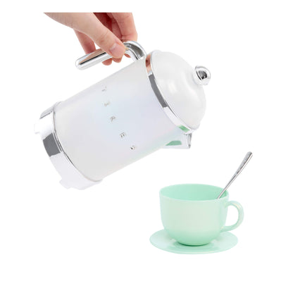 Hand "pouring" the tea pot into a green cup on a white background