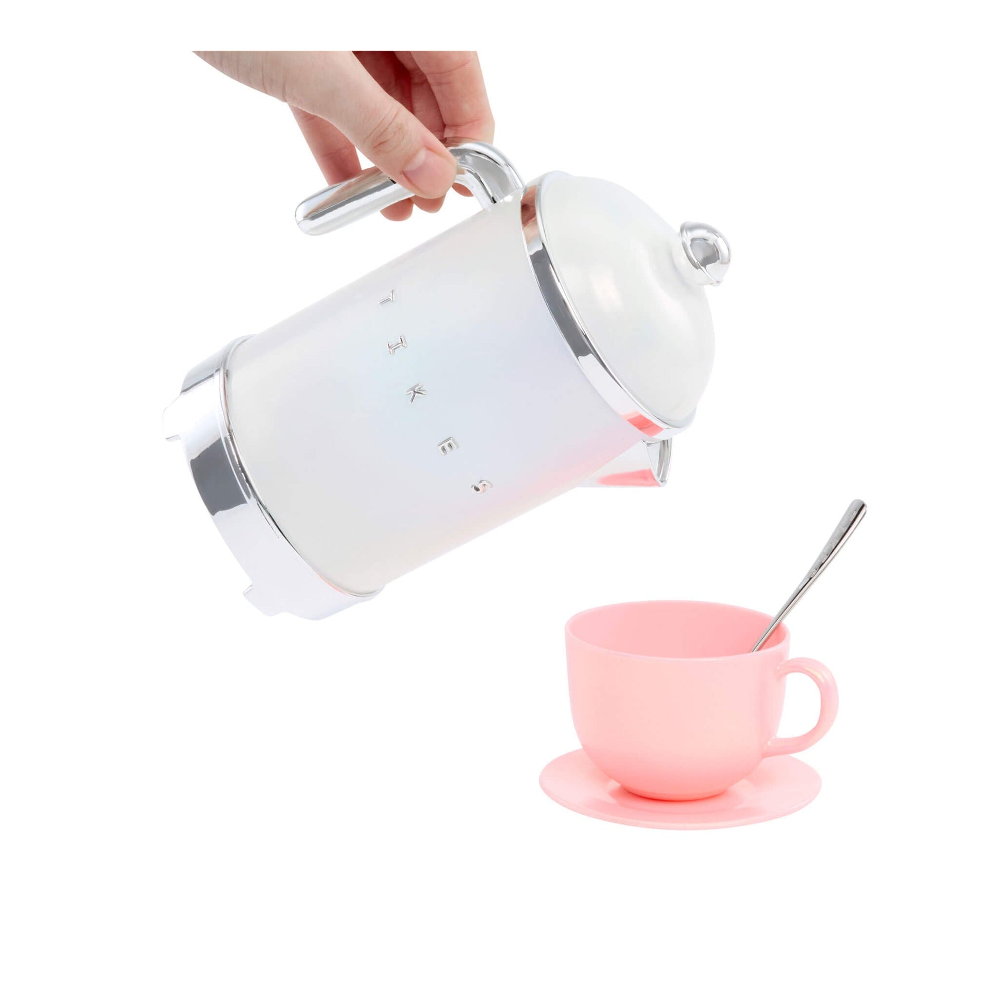 White tea pot being used with a pink cup and spoon on a white background