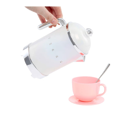 White tea pot being used with a pink cup and spoon on a white background
